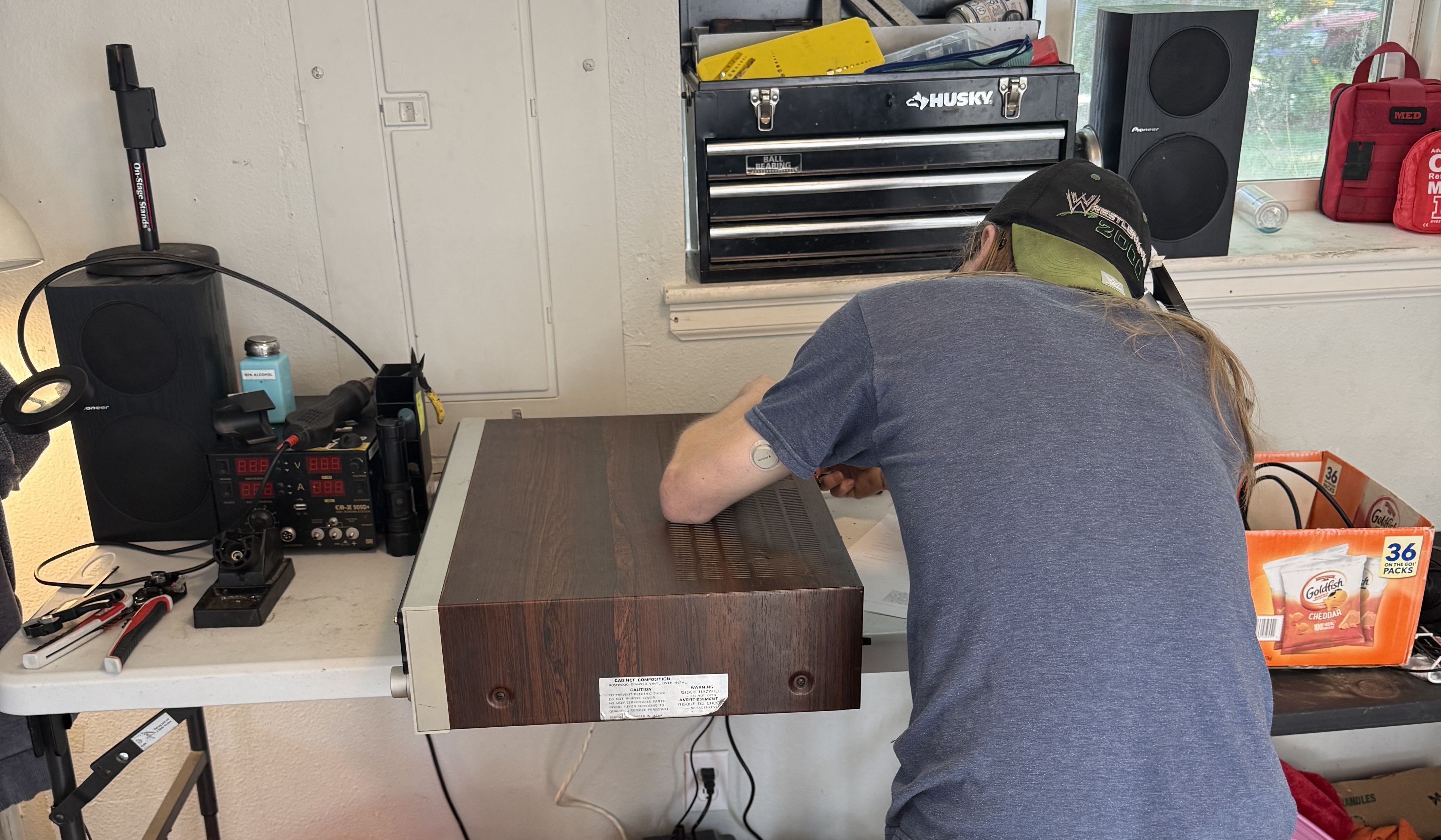 Tj working on a rosewood-cased vintage tuner amplifier